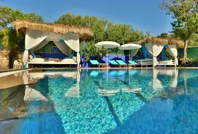 B&B Boutique Hotel Dalyan – Havuz kenarında palmiyeler ve bambu şezlonglarla doğayla iç içe butik otel atmosferi